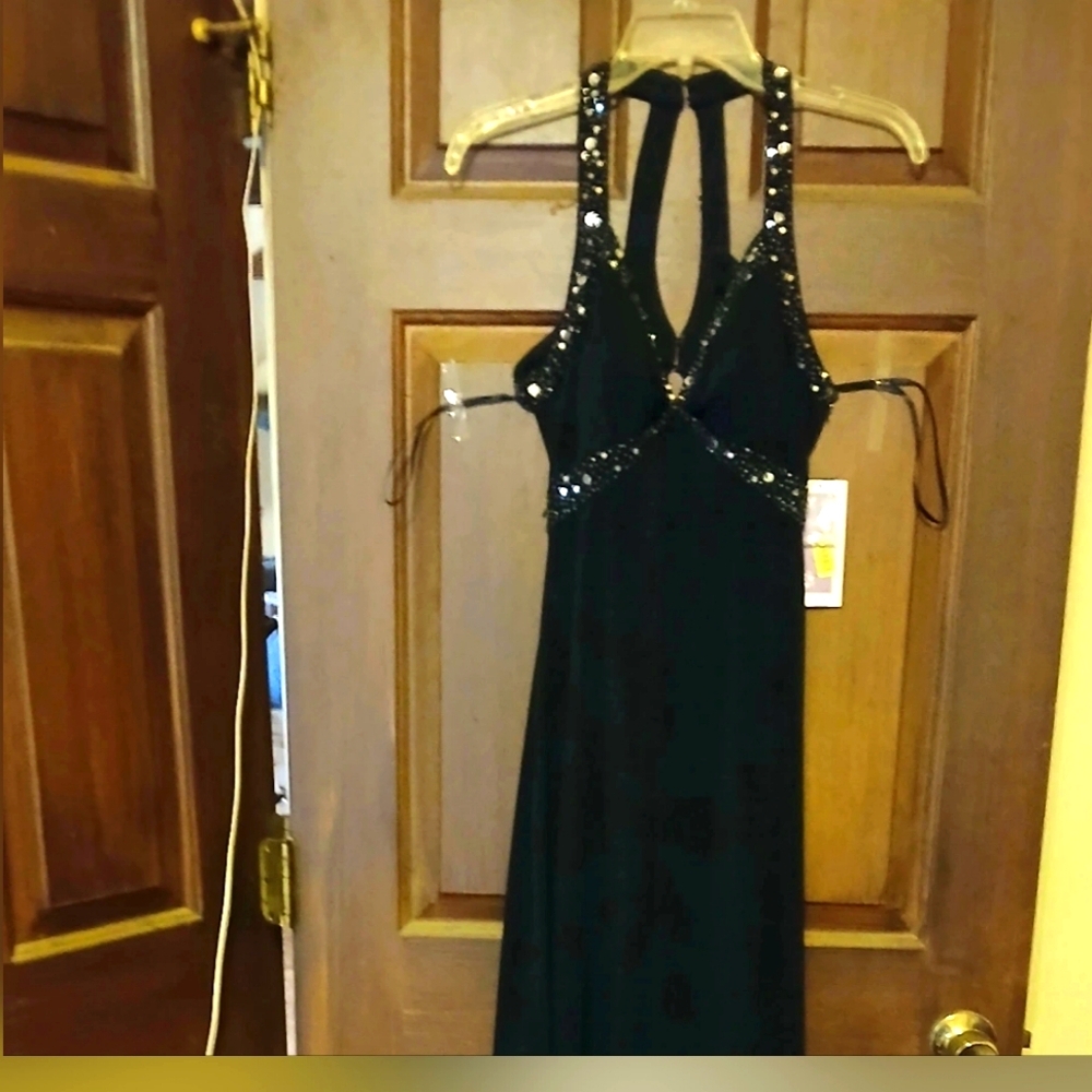Formal black dress with silver sequins and unique cut out back low to the back.